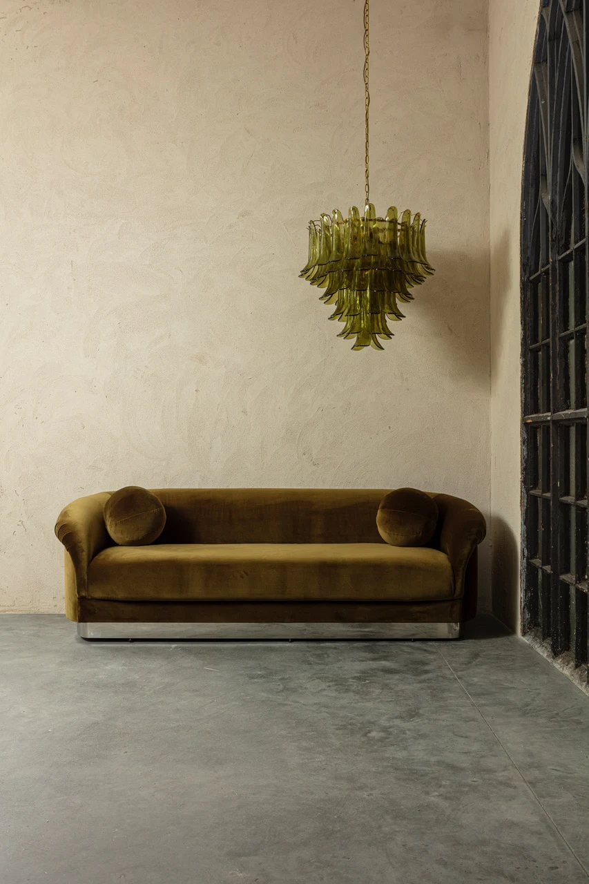 Living space with mustard velvet sofa and decorative pendant light