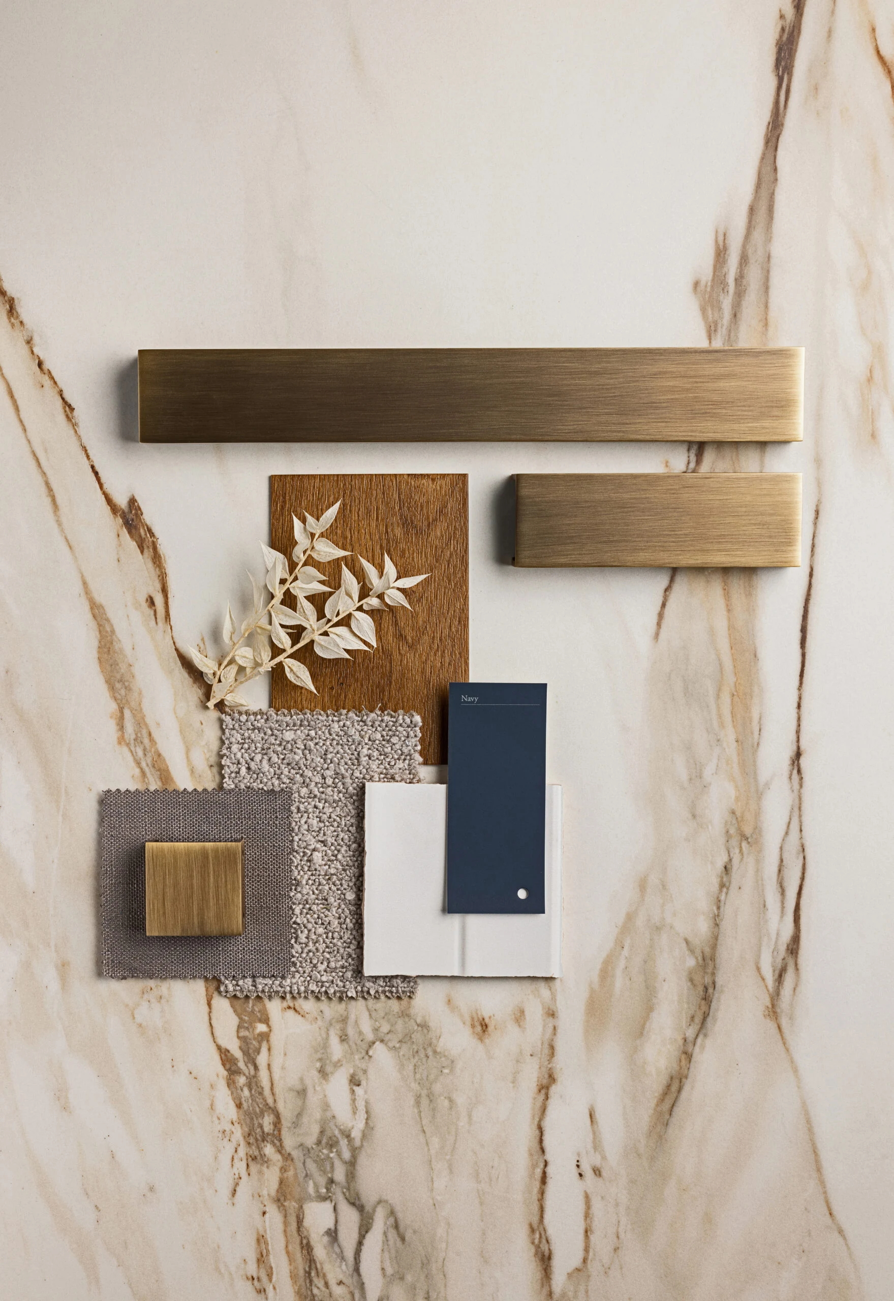 Material moodboard with marble, timber and brass finishes