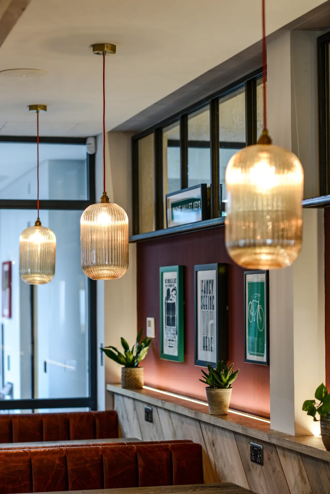 Cafe interior with amber pendant lights and banquette seating